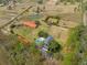 An aerial view showcases a large property featuring multiple buildings and a large pool at 4801 Coon Club Rd, Meggett, SC 29449