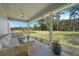 Spacious covered porch featuring comfortable outdoor seating, ideal for enjoying tranquil views of the surrounding landscape at 4801 Coon Club Rd, Meggett, SC 29449