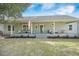 Inviting back porch with comfortable seating, offering a perfect spot to enjoy the serene outdoor views and fresh air at 4801 Coon Club Rd, Meggett, SC 29449