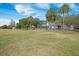 Expansive backyard with lush lawn, mature trees, and partial view of the house with a private pool at 4801 Coon Club Rd, Meggett, SC 29449