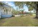 A spacious backyard view features a covered porch, fenced pool, and mature trees at 4801 Coon Club Rd, Meggett, SC 29449