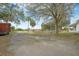 Spacious backyard with an in-ground pool, mature trees, and views of the home's exterior at 4801 Coon Club Rd, Meggett, SC 29449