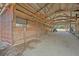 Barn interior featuring a tractor, stalls, and ample storage space beneath a high ceiling at 4801 Coon Club Rd, Meggett, SC 29449