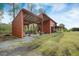 Spacious red barn featuring a covered area and a large enclosed storage space at 4801 Coon Club Rd, Meggett, SC 29449