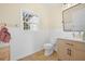 Well-lit half bath with neutral tones, vanity, and ceramic tile flooring at 4801 Coon Club Rd, Meggett, SC 29449