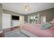 Bedroom with wood floors, sliding glass doors to a deck, tv, and private bath access at 4801 Coon Club Rd, Meggett, SC 29449