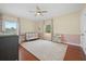 Bright Bedroom with wood floors, gray crib, neutral walls, ceiling fan, and large windows at 4801 Coon Club Rd, Meggett, SC 29449