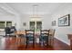 Dining room with wood table set, views of the backyard from the large window, hardwood floors at 4801 Coon Club Rd, Meggett, SC 29449