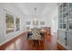 Dining room with wood table set on hardwood floor, bright light from large window, built-in hutch at 4801 Coon Club Rd, Meggett, SC 29449