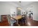 Open-concept dining area with hardwood floors, wooden table set, and natural lighting at 4801 Coon Club Rd, Meggett, SC 29449