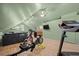 A spacious exercise room area features light floors, unique ceilings, and exercise equipment at 4801 Coon Club Rd, Meggett, SC 29449