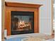 Cozy fireplace with a wooden mantle and brick hearth, providing warmth and ambiance at 4801 Coon Club Rd, Meggett, SC 29449