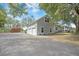 Detached two-story garage with a multi-car driveway, white trim, and upper-level windows at 4801 Coon Club Rd, Meggett, SC 29449
