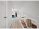 Upstairs hallway showcasing hardwood floors, white walls, railings, and an adjacent living room at 4801 Coon Club Rd, Meggett, SC 29449