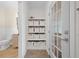 Hallway with storage cubes, tile flooring and neutral colors at 4801 Coon Club Rd, Meggett, SC 29449