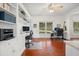 Bright home office with built-in desks, cabinets, natural light, and views of the outdoors at 4801 Coon Club Rd, Meggett, SC 29449