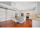 Bright kitchen features stainless steel appliances, white cabinetry, granite counters and a cozy banquette seating area with table at 4801 Coon Club Rd, Meggett, SC 29449