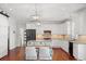 Well-lit kitchen with white cabinetry, stainless steel appliances, granite counters, and a built-in banquette seating area at 4801 Coon Club Rd, Meggett, SC 29449