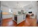 Bright and open kitchen with stainless steel appliances, a center island with seating, flowing into the living area at 4801 Coon Club Rd, Meggett, SC 29449