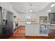 Open kitchen with stainless steel appliances, white cabinets, granite island with seating, and breakfast nook, perfect for Gathering gatherings at 4801 Coon Club Rd, Meggett, SC 29449