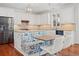 Beautiful kitchen featuring white cabinetry, stainless steel appliances, granite counters, and a breakfast nook with built-in bench seating at 4801 Coon Club Rd, Meggett, SC 29449