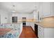 Spacious kitchen with white cabinetry, stainless steel appliances, granite countertops, and a charming breakfast nook with built-in seating at 4801 Coon Club Rd, Meggett, SC 29449