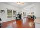 Bright office space features hardwood floors, a large window, and seamless transition to dining area at 4801 Coon Club Rd, Meggett, SC 29449