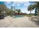 A luxury pool is surrounded by lounge furniture, shade trees, and a fenced perimeter at 4801 Coon Club Rd, Meggett, SC 29449