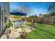 Backyard with table set, hammock, manicured lawn, and wood fence at 5024 Wapiti Way, Hollywood, SC 29449