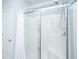 Clean bathroom featuring a glass-enclosed shower with a chrome showerhead and a white shower curtain at 5024 Wapiti Way, Hollywood, SC 29449