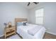 Cozy bedroom with a ceiling fan, a window with blinds, and light wood nightstand and headboard at 5024 Wapiti Way, Hollywood, SC 29449