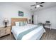 Well-lit bedroom features a ceiling fan, a window with blinds, and light wood furniture with lamps at 5024 Wapiti Way, Hollywood, SC 29449