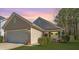 Charming single-story home featuring an attached two-car garage and inviting front porch, perfect for relaxing at 5024 Wapiti Way, Hollywood, SC 29449