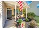 Inviting covered front porch with chairs and plants, creating a cozy and welcoming entrance to the home at 5024 Wapiti Way, Hollywood, SC 29449