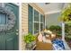 Inviting covered front porch with chairs and plants, creating a cozy and welcoming entrance to the home at 5024 Wapiti Way, Hollywood, SC 29449