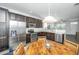 Bright, open kitchen features stainless steel appliances, dark wood cabinets, and a dining area at 5024 Wapiti Way, Hollywood, SC 29449