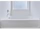 A white bathtub situated under a window, providing natural light for a bright and relaxing bathing space at 505 Greywood Ln, Goose Creek, SC 29445