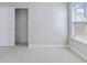 A bright bedroom with neutral walls and carpet, a window, and a walk-in closet, providing a serene space at 505 Greywood Ln, Goose Creek, SC 29445