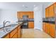 Functional kitchen featuring black appliances, granite countertops, wood cabinets and tile backsplash at 505 Greywood Ln, Goose Creek, SC 29445