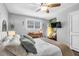 Well-lit bedroom with comfortable bed, ceiling fan, and mounted television at 507 Stinson Dr # 5E, Charleston, SC 29407