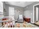 Charming Bedroom with crib, rocking chair, hardwood floors and ample natural light at 507 Stinson Dr # 5E, Charleston, SC 29407