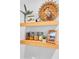 Rustic shelves hold pictures, a plant, and decorative storage containers at 507 Stinson Dr # 5E, Charleston, SC 29407