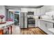 Modern kitchen featuring stainless steel appliances, white cabinets and a sliding glass door to a private patio at 507 Stinson Dr # 5E, Charleston, SC 29407