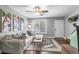 Bright and airy living room boasting a comfortable sofa, ceiling fan, and access to the outside at 507 Stinson Dr # 5E, Charleston, SC 29407