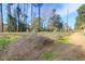 Street view showing trees, foliage, and a glimpse of nearby homes, presenting a tranquil neighborhood setting at 507 Stinson Dr # 5E, Charleston, SC 29407