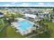 Aerial shot of a neighborhood pool and recreation center surrounded by palm trees, landscaping and cozy homes at 509 Rhythm St, Summerville, SC 29486
