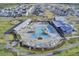 Aerial view highlighting a resort-style pool surrounded by lush landscaping and modern homes at 509 Rhythm St, Summerville, SC 29486