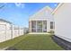 Backyard of new home featuring fenced yard, screen porch and lush green grass at 509 Rhythm St, Summerville, SC 29486