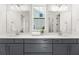 Bright bathroom features double vanity with gray cabinets, white countertop, and large mirror at 509 Rhythm St, Summerville, SC 29486