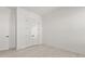 Minimalist bedroom with white walls, modern door, and neutral flooring at 509 Rhythm St, Summerville, SC 29486